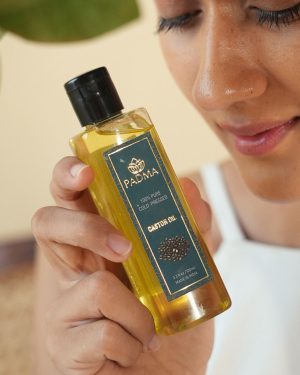 Person holding Padma 100% pure cold-pressed castor oil image on padma home page