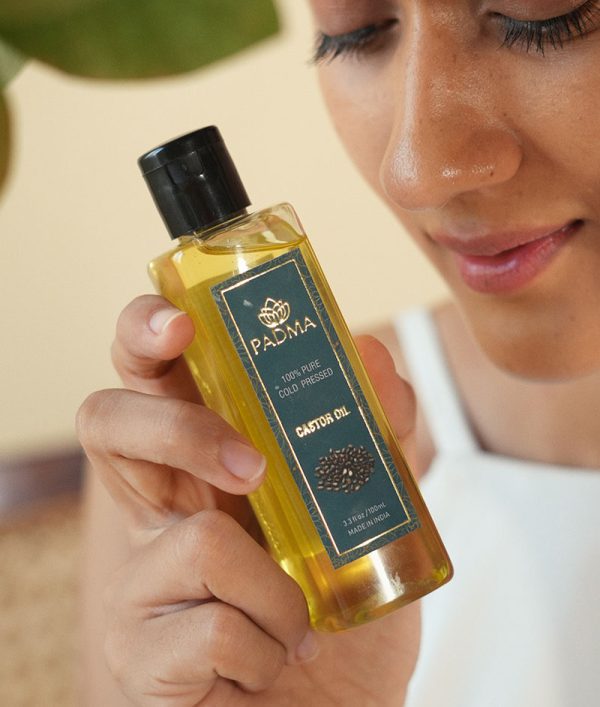 Person holding Padma 100% pure cold-pressed castor oil image on padma home page