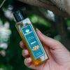 Hand holding bottle of 100% pure cold-pressed olive oil image on padma home page
