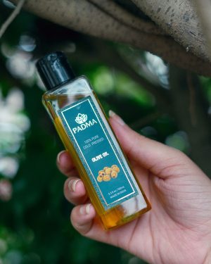 Hand holding bottle of 100% pure cold-pressed olive oil image on padma home page