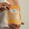 Hand holding Padma Chandan Powder for face and skin image on padma home page