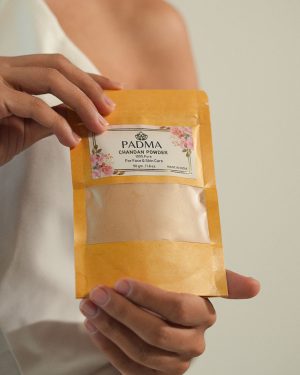 Hand holding Padma Chandan Powder for face and skin image on padma home page