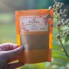 Hand holding Padma Moringa Leaf Powder pack image on padma product category page