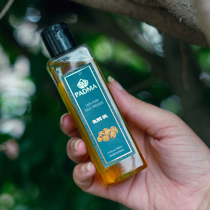 Hand holding Padma 100% pure cold-pressed olive oil image on padma gallery page