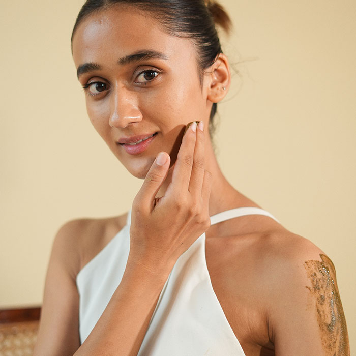 woman applying product to her face and shoulder image on padma gallery page